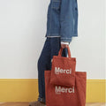 パリ発merciのテラコッタ×ホワイトのトートバッグ